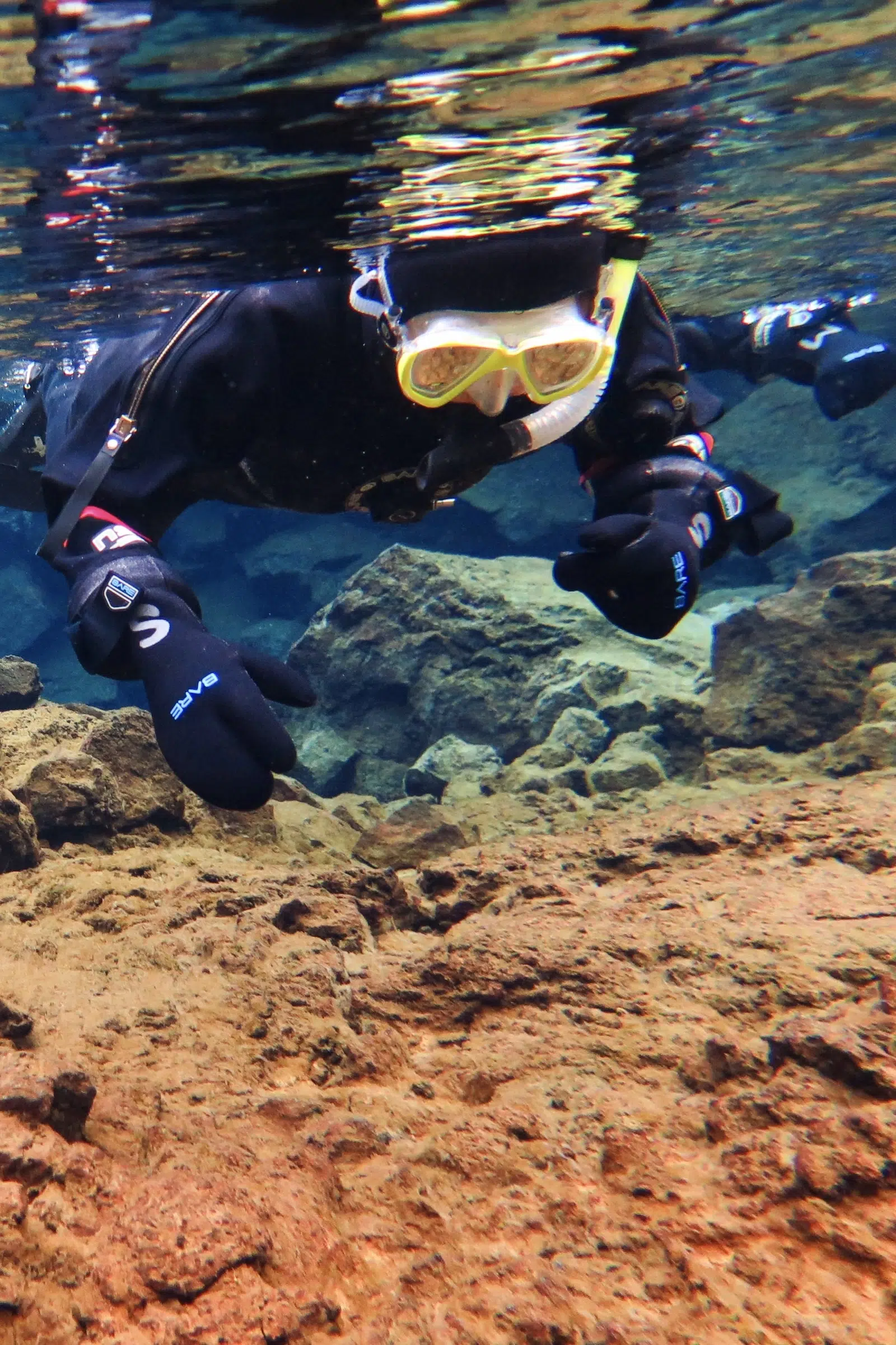 Snorkeler between the Silfra tectonic plates